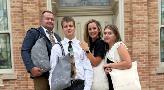 Family posing in front of temple with temple bags