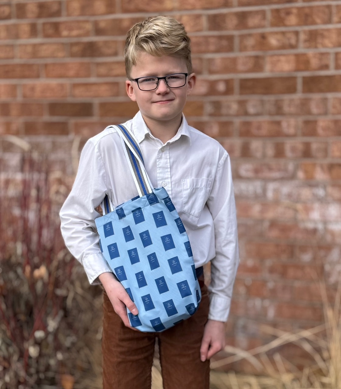 Young boy with Everyday Scripture and Little Church Tote