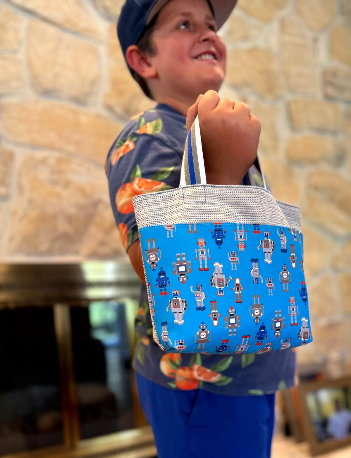 Young boy with a blue gray Children's Scripture Bag with robots print