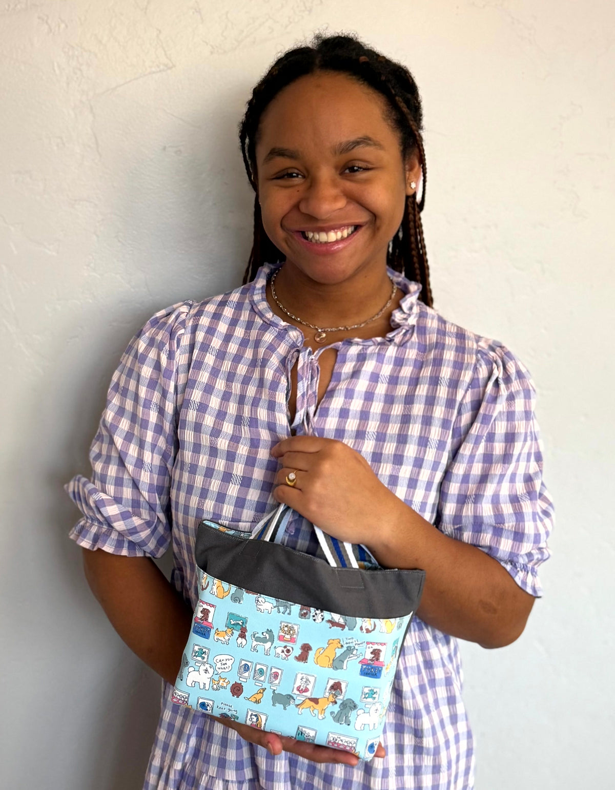 Young girl with a dark gray Children's Scripture Bag with puppies print