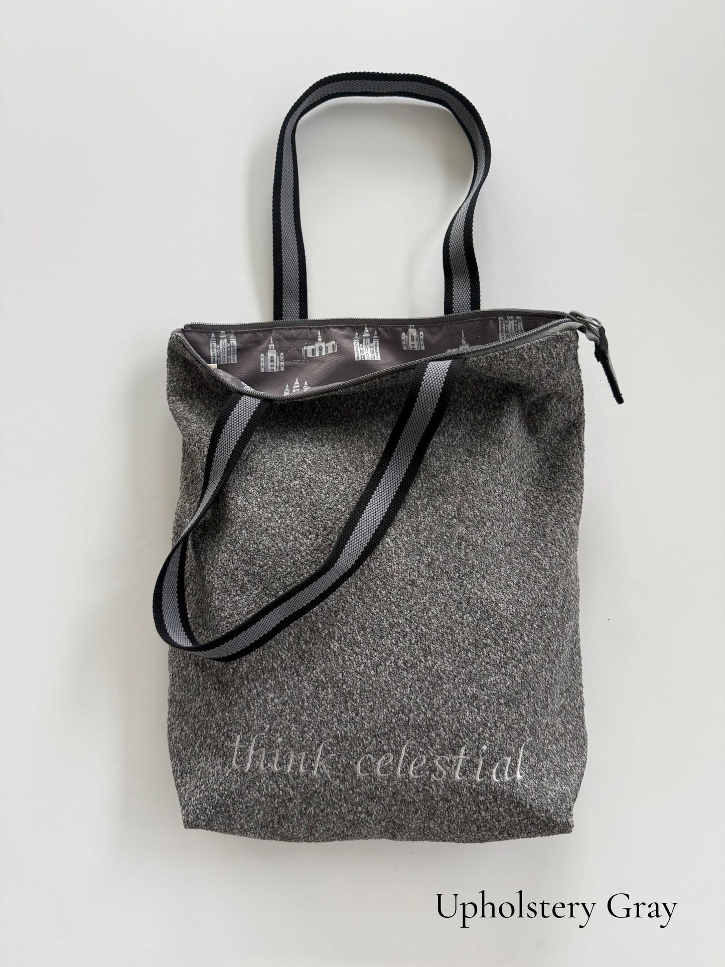 Upholstery Gray temple bag with gray and black striped strap and temples lining, embroidered with “think celestial”