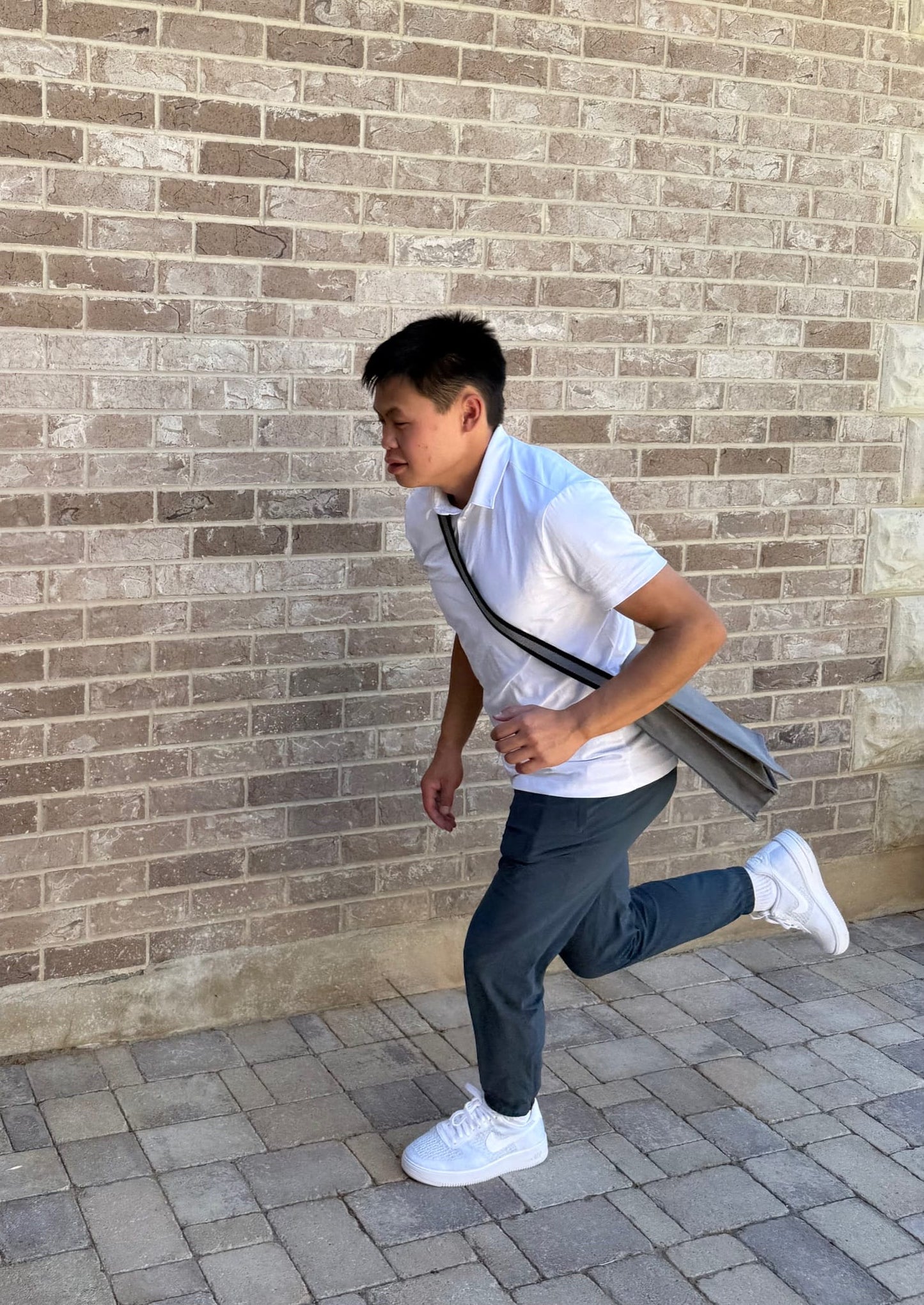 Man running while carrying the Iron Rod Missionary Messenger Bag