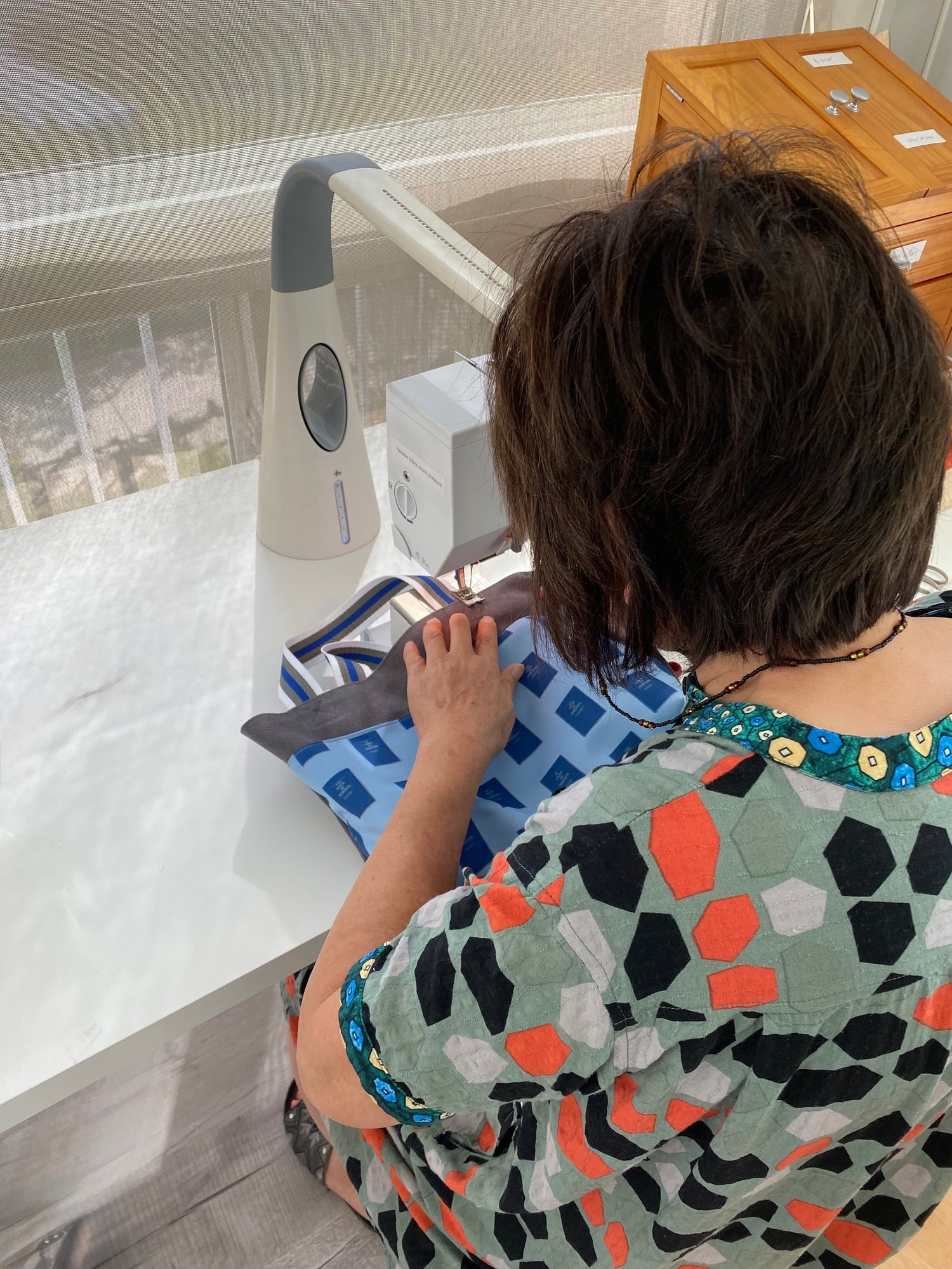 Isabella working at her sewing machine