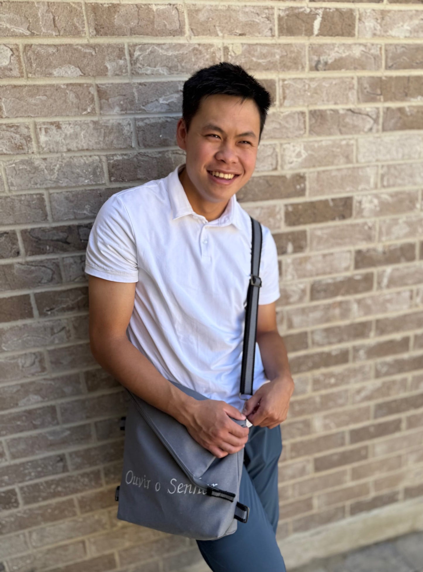 Man posing with the Go and Do Missionary Bag