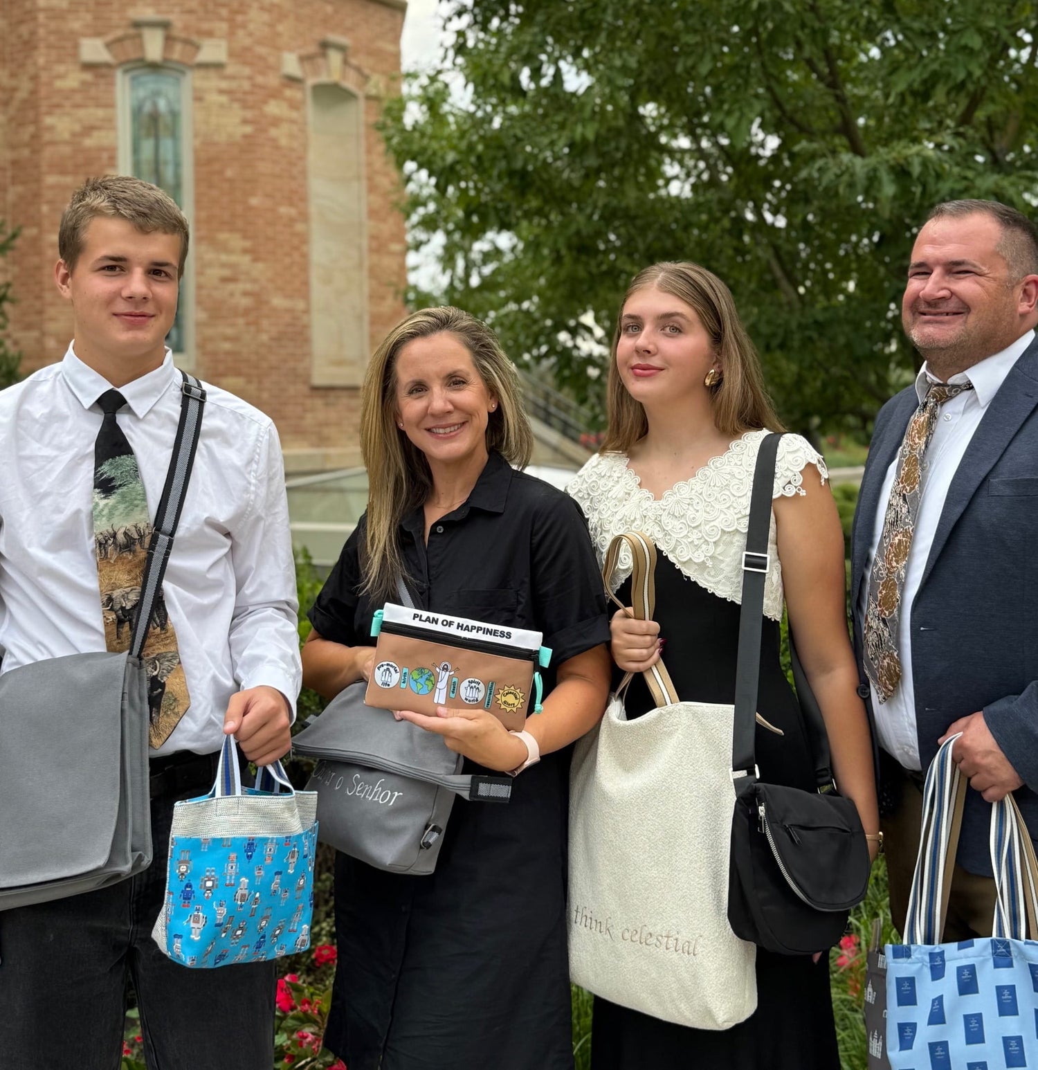 Family posing with their QA Bags
