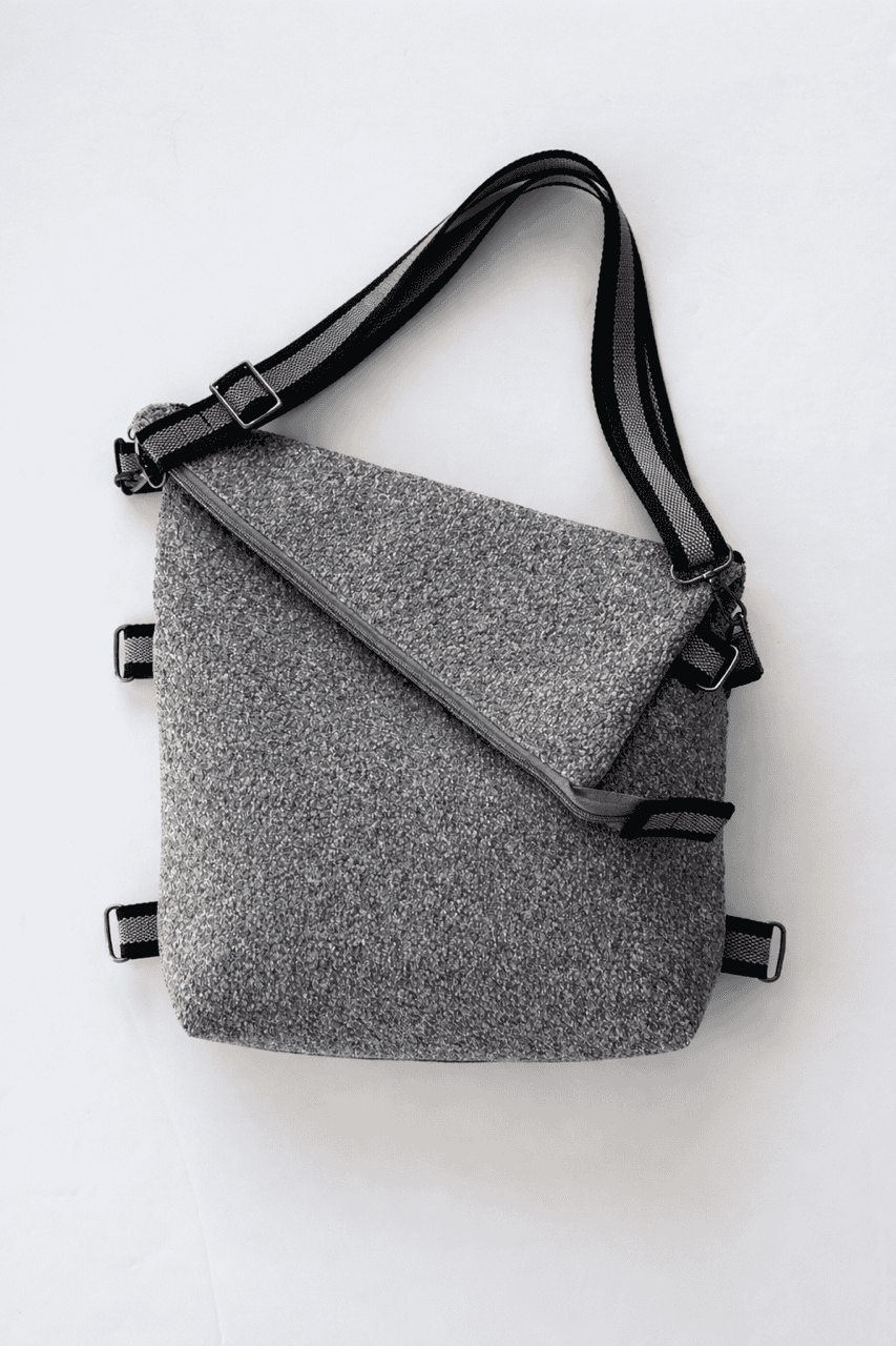 Upholstery Gray 3-In-1 convertible missionary bag crossbody style with an adjustable black-and-gray strap.