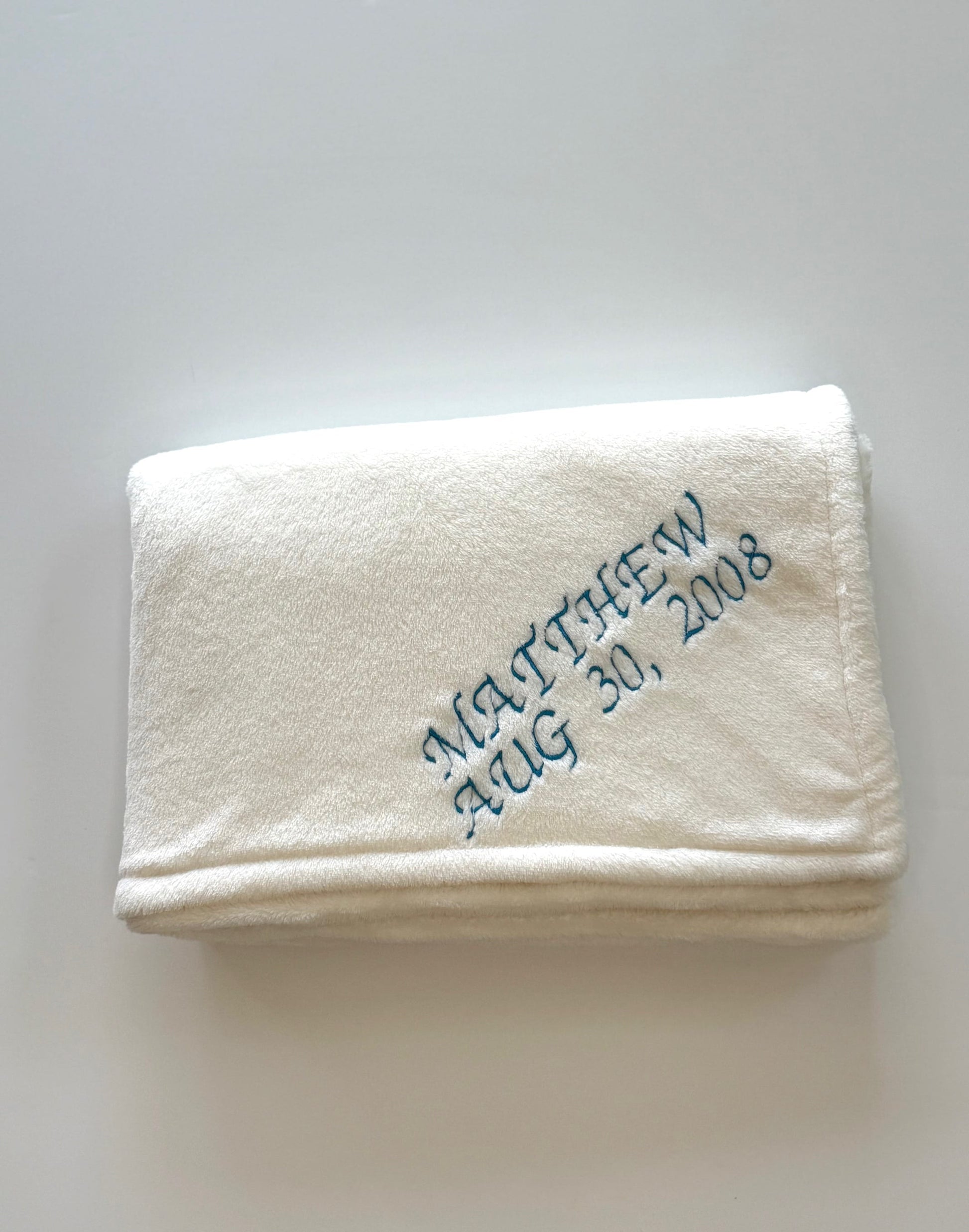 Baptism blanket with blue thread embroidery