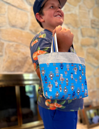 Young boy with a blue gray with robots Children's Scripture Bag