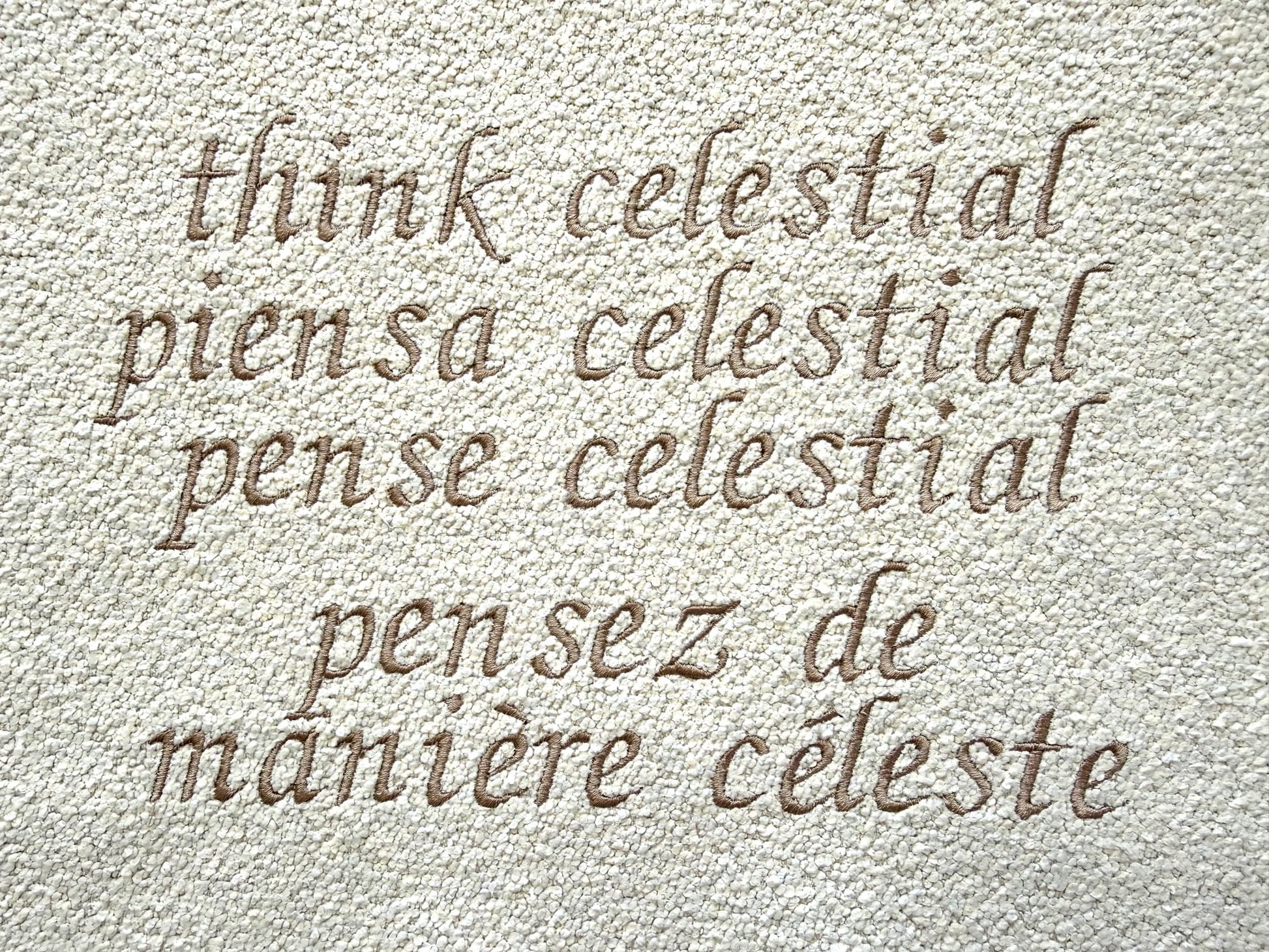 'Think Celestial' in various languages on a textured beige background