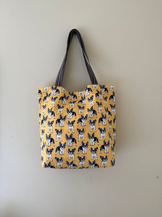 Yellow bag with a dog pattern on a plain background