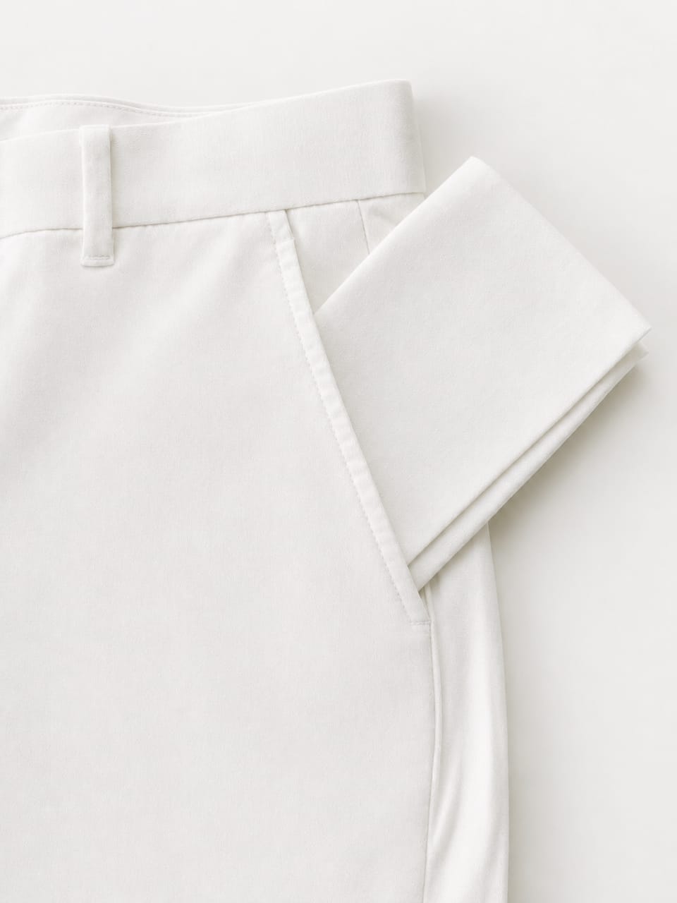 White cotton temple pouch tucked into front pocket of temple pants
