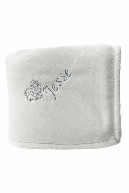 White faux fur blanket with the name 'Jesse' embroidered