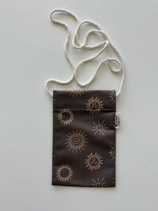Small brown pouch with sun patterns and a white cotton lanyard