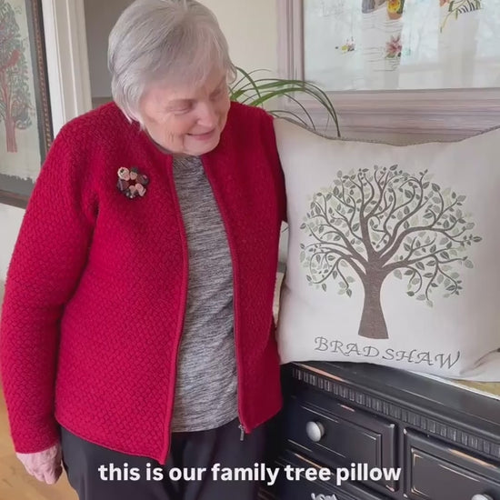 A woman talks about her Family Tree Pillow, emphasizing its quality and how well it complements the colors in her home.