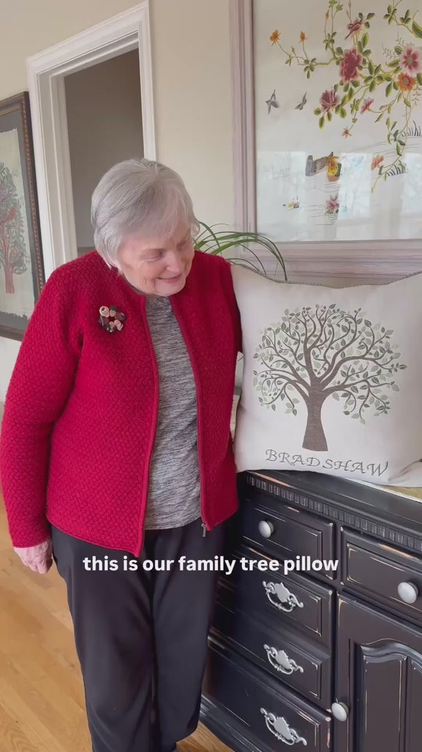 A woman talks about her Family Tree Pillow, emphasizing its quality and how well it complements the colors in her home.