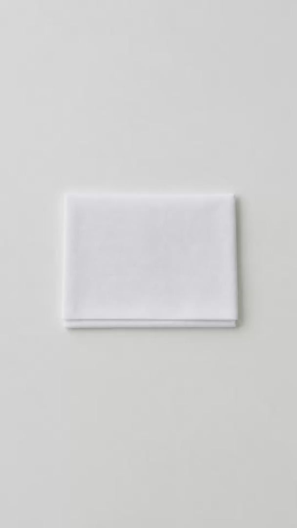 White folding temple card holder shown closed, open with cards inside, and tucked into a dress pocket