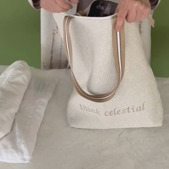 Putting clothing in Classic Temple Bag